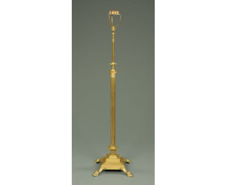 A Victorian brass lamp standard, with adjustable mechanism and stepped base and raised on paw feet.   CONDITION REPORT:  Heig