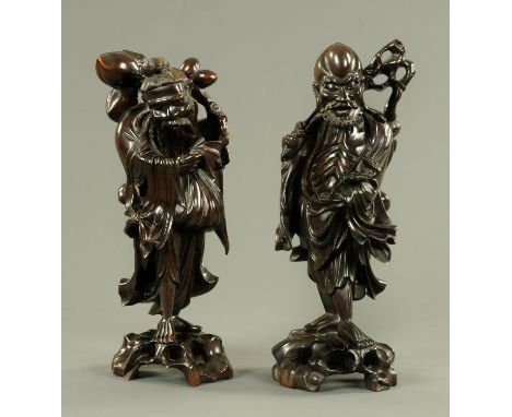Two Chinese carved wood deities, early 20th century, one holding a branch of peaches, the other with a fly whisk and Ruyi sce