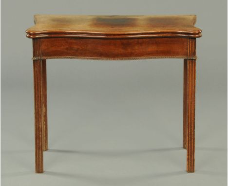 A George III mahogany serpentine fronted card table, with green baize lined interior and raised on moulded legs.  Width 82.5 
