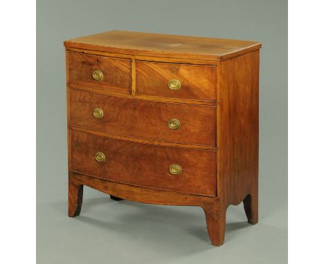 A 19th century mahogany bowfronted chest of drawers, two short and two long drawers with brass drop handles with oval backpla