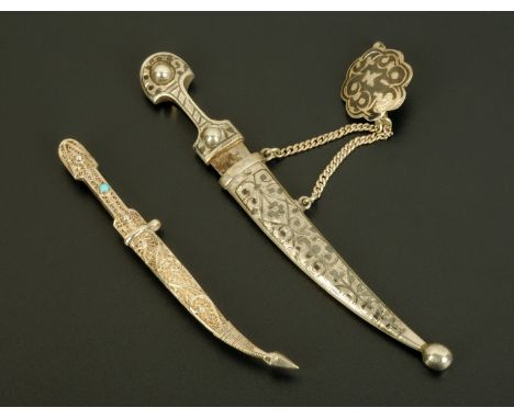 A Russian silver and niello paper knife, and a knife and scabbard bar brooch.  Longest 13.5 cm.  