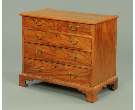 A George III mahogany chest of drawers, with applied moulded edge above two short and three long graduated drawers with brass