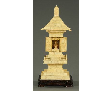 A Japanese carved ivory and bone shrine, late 19th century, the finial carved with a phoenix upon lotus carved roof above two