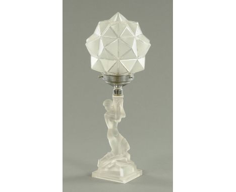 An Art Deco moulded glass table lamp, circa 1930's, having a star cluster shade in chromium mount above a semi clad female kn