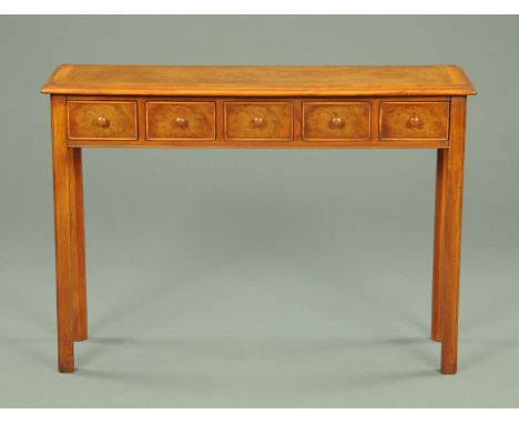 A walnut crossbanded five drawer console table, with wooden knob handles and raised on moulded legs.  Width 108 cm. 