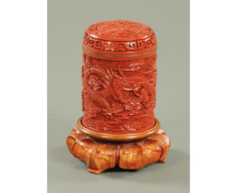 A Chinese Cinnabar lacquer jar and cover, mid 20th century, the cover carved with a dragon amongst clouds and with lotus scro