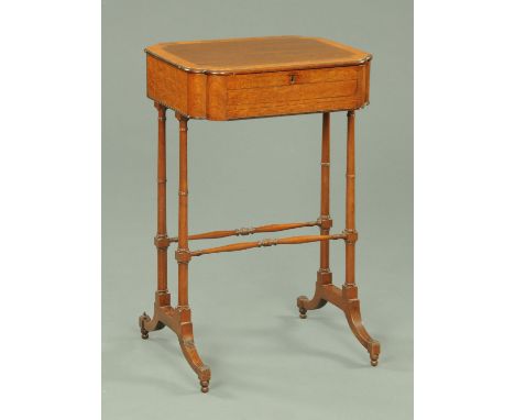 A Regency mahogany satinwood banded worktable, with lift up top, ring turned supports and downswept legs terminating in short