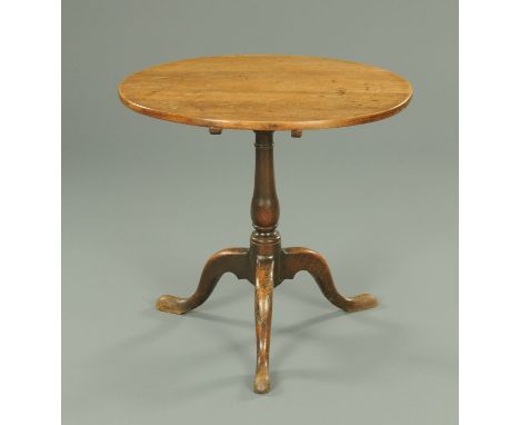 A George III mahogany tripod table, with snap action, turned column and three downswept legs terminating in pad feet.  Diamet