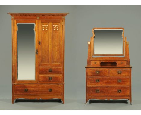 A late 19th century Arts & Crafts wardrobe and dressing chest, the wardrobe with detachable moulded cornice above a three qua