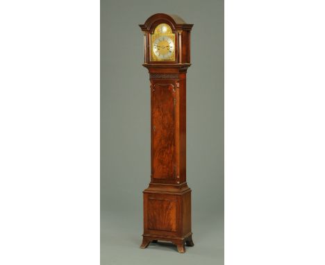 An Edwardian figured mahogany Grandmother clock, with arched hood and two-train weight driven movement, with blind fretwork c