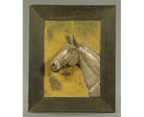 A silver plated relief portrait of the head of a racehorse.  30 cm x 22 cm, framed, signed.