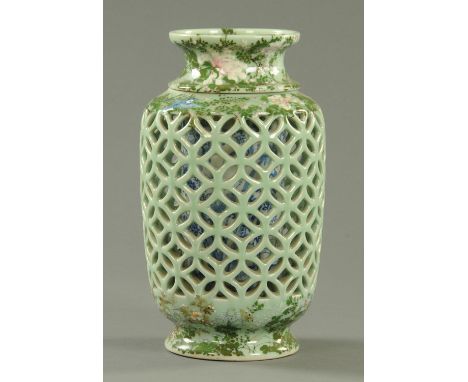 An unusual Japanese Seto reticulated vase, circa 1900, the pierced exterior with pierced cash design between relief moulded e