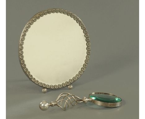 A Victorian magnifying glass, with silver plated mount and handle, and a circular easel backed mirror with plated rim, diamet