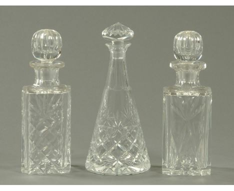 A pair of square bodied cut glass spirit decanters, and a Brierley inverted tapering decanter 27-29 cm