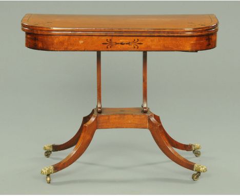 A Regency card table, with turnover top, rounded corners and raised on silhouette supports with quatreform base, sabre legs a