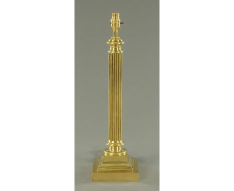 A brass column table lamp, with square stepped base.  Height including light fitting 54 cm.