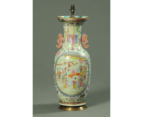 A large Cantonese vase, with table lamp conversion, decorated in typical Canton colours with panels of figures and floral spr