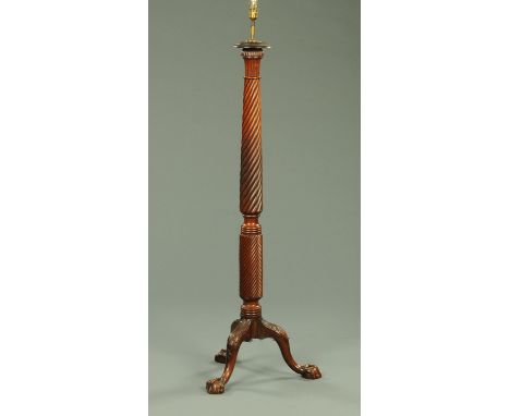 A mahogany bed post lamp standard, with three downswept foliate carved legs terminating in claw and ball feet.