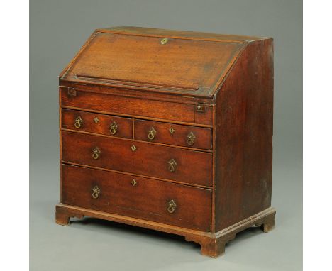 An 18th century oak bureau, fitted interior with well, having two short and two long drawers, and raised on bracket feet.  Wi