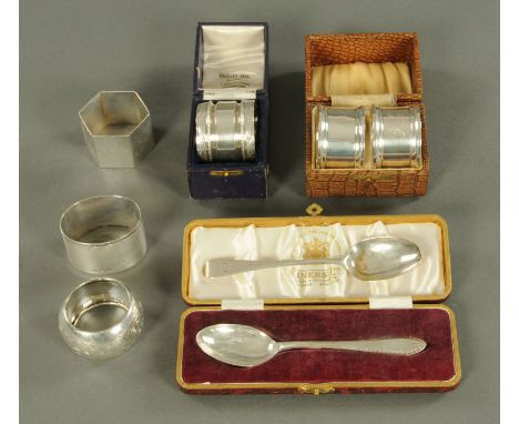 A pair of silver napkin rings, three silver napkin rings, a white metal napkin ring and two silver teaspoons, various dates a