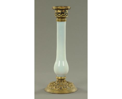 A Victorian opalescent glass oil lamp, 19th century, with gilt metal mounts, the stem with a slender baluster to the base and