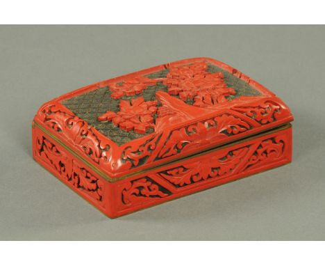 A Chinese Cinnabar lacquer table box, mid 20th century, the lid decorated with rock work and peony against a black ammonite s