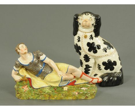 A 19th century Staffordshire figure of Anthony, and a Staffordshire Spaniel.     CONDITION REPORT:  There is a patch of glaze