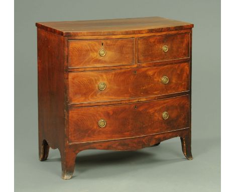 A George III mahogany bowfronted chest of drawers, with two short and two long drawers with brass drop handles with circular 