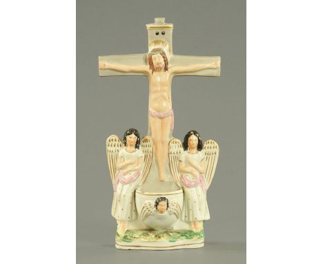 A Staffordshire earthenware holy water stoop, 19th century, modelled as Christ on the cross above two angels flanking the sto
