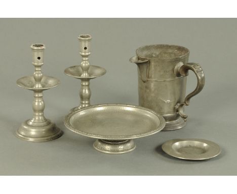 A pair of pewter candlesticks, 19th century, with wide drip trays and domed bases, 19 cm, a 19th century quart jug, engraved 