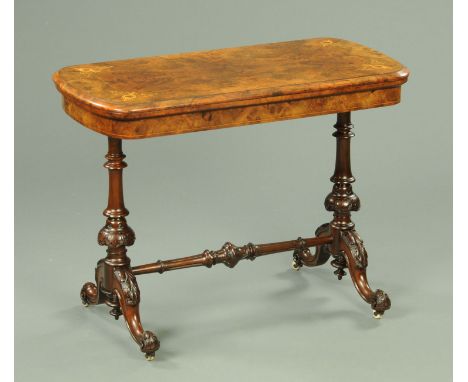 A Victorian inlaid walnut turnover top card table, with green baize lined interior and raised on turned columns with downswep
