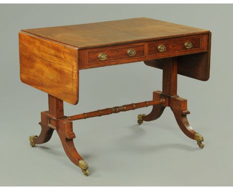 A George III mahogany sofa table, twin drop flap, fitted with two frieze drawers with brass drop handles and oval backplates 