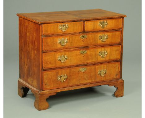 An 18th century walnut chest of drawers, with crossbanded moulded edge above two short and three long graduated drawers with 