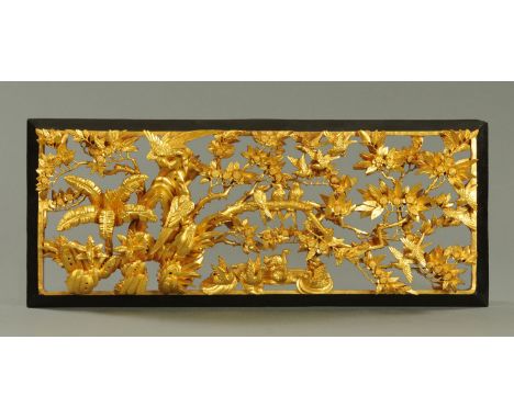 A Chinese Chaozhou style carved and gilded wood panel, mid to third quarter 20th century, carved with numerous birds amongst 