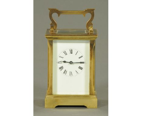 A brass carriage clock, circa 1900, with white enamel dial, Roman numerals and eight day movement stamped "A.C.G. A.C. Gibson