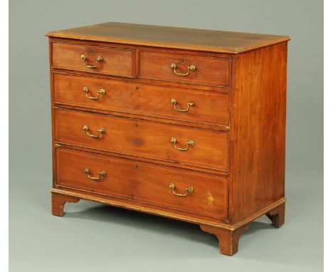 A George III mahogany chest of drawers, with moulded edge above two short and three long graduated drawers with brass drop ha