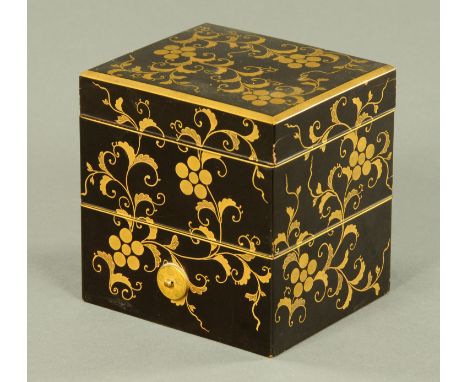 A small Japanese lacquered Jubako, Meiji period, comprising of two stacking boxes and a cover with gilt scrolling frond decor