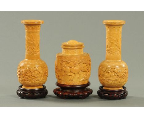 A pair of Chinese carved bamboo vases, circa 1960/70's, carved with carp amongst waves and reeds above opposing dragons chasi