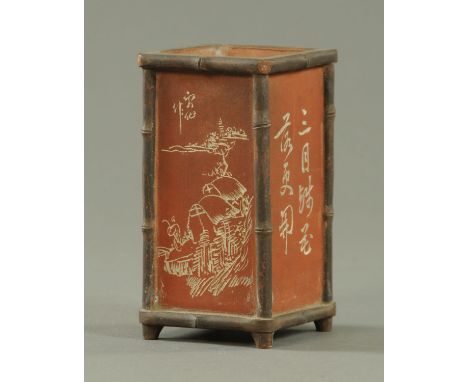 A Chinese terracotta brush pot, circa 1900, slab form, with relief moulded faux bamboo borders and Sgraffito panels decorated