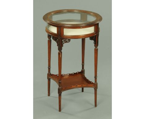 An Edwardian mahogany blind fretwork carved circular bijouterie table, raised on tapered legs of square section with low shel