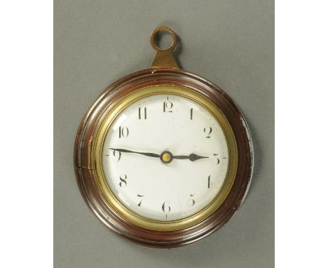 A sedan clock, early 19th Century, having an enamel dial with Arabic numerals within a turned lignum mount with brass back pl