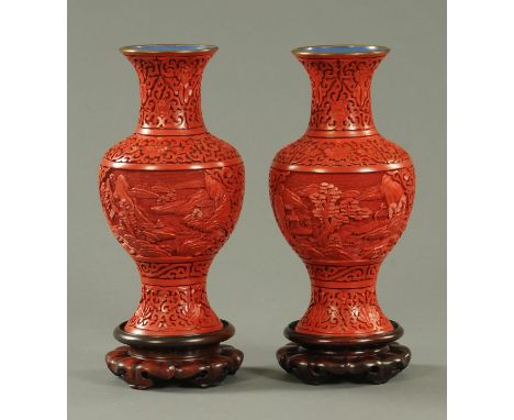 A pair of Chinese Cinnabar lacquer vases, mid 20th century, the body with landscape decoration of buildings with pine trees, 