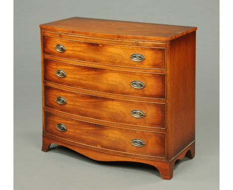 A Reprodux mahogany crossbanded bowfronted chest of drawers, with slide and four graduated drawers with brass drop handles, r