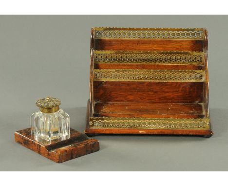 A late Victorian oak stationery rack, with pierced brass gallery, and an inkwell and pen stand.   CONDITION REPORT:  The stat