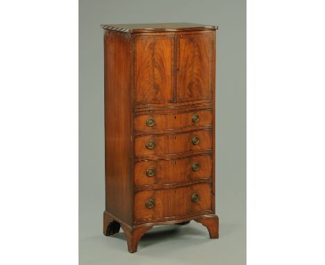 A mahogany reproduction serpentine fronted cupboard and combined chest, with ebony line inlay, four graduated drawers and rai