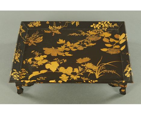 A good Japanese lacquered tea ceremony tray, Meiji period, decorated with low relief gilt chrysanthemums, peony, wisteria and