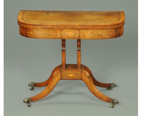 A Regency inlaid rosewood crossbanded turnover top card table, with four downswept legs with brass capped castors.  Width 91 