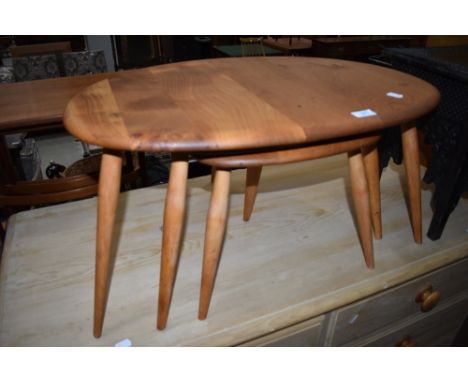 A stripped Ercol pebble style nest of three tables