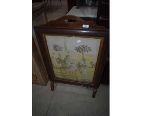 An early 20th Century oak fire screen having tapestry inset, Arabian theme