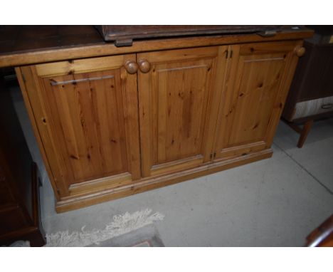 A pine and tile top counter, with triple cupboard, width approx 135cm